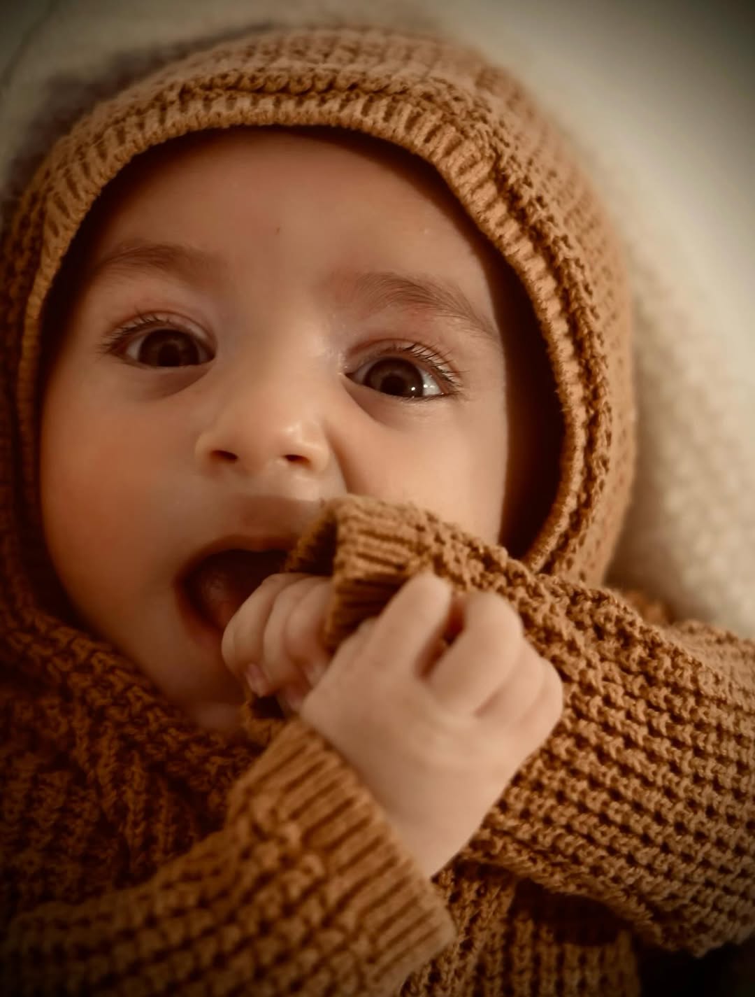 Newborn in knitted wrap